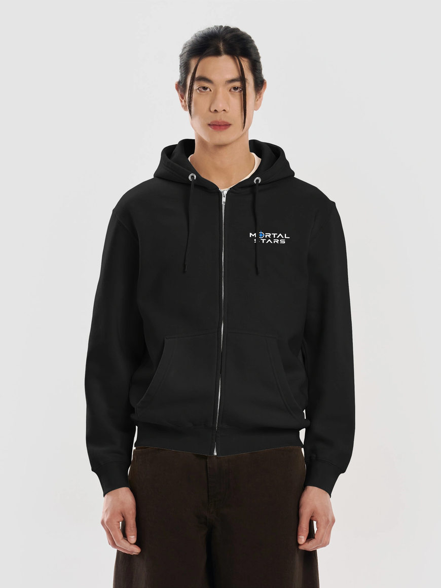 Model wearing a black zip hoodie with a small white Mortal Stars chest logo